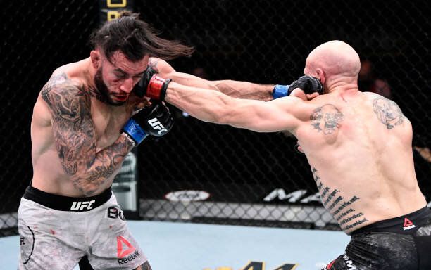 Josh Emmett cracks Shane Burgos with a left hand. Credit: The Fight Sight.
