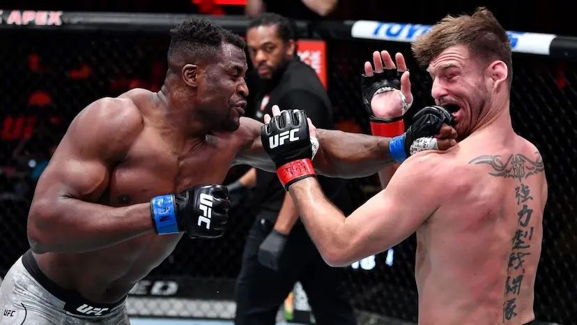 Francis Ngannou landing a left straight which knocks Stipe Miocic down. Credits to: Jeff Botari - Zuffa LLC.