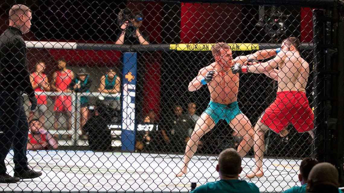 Brad Katona landing a lead hook on Timur Valiev. Credits to: UFC.