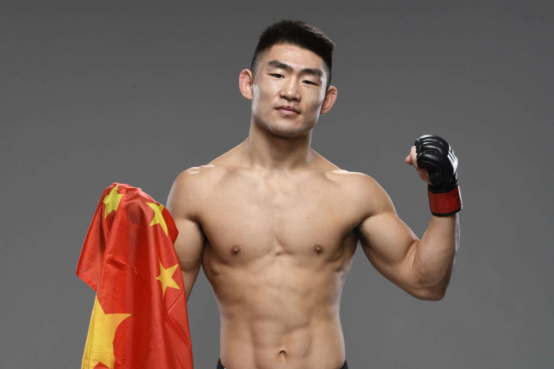 Song Yadong proudly holding a Chinese flag.  Credits to: Mike Roach-Zuffa LLC