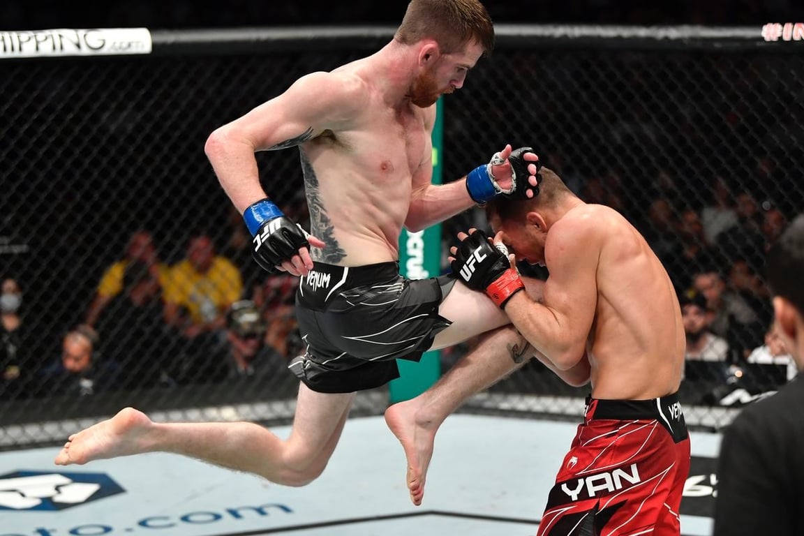 Cory Sandhagen landing a flying knee on Petr Yan. Credits to: Zuffa LLC.