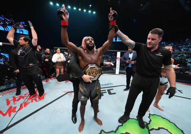 Aljamain Sterling getting the belt wrapped around his waist after defeating TJ Dillashaw. Credits to: Chris Unger-Getty Images.