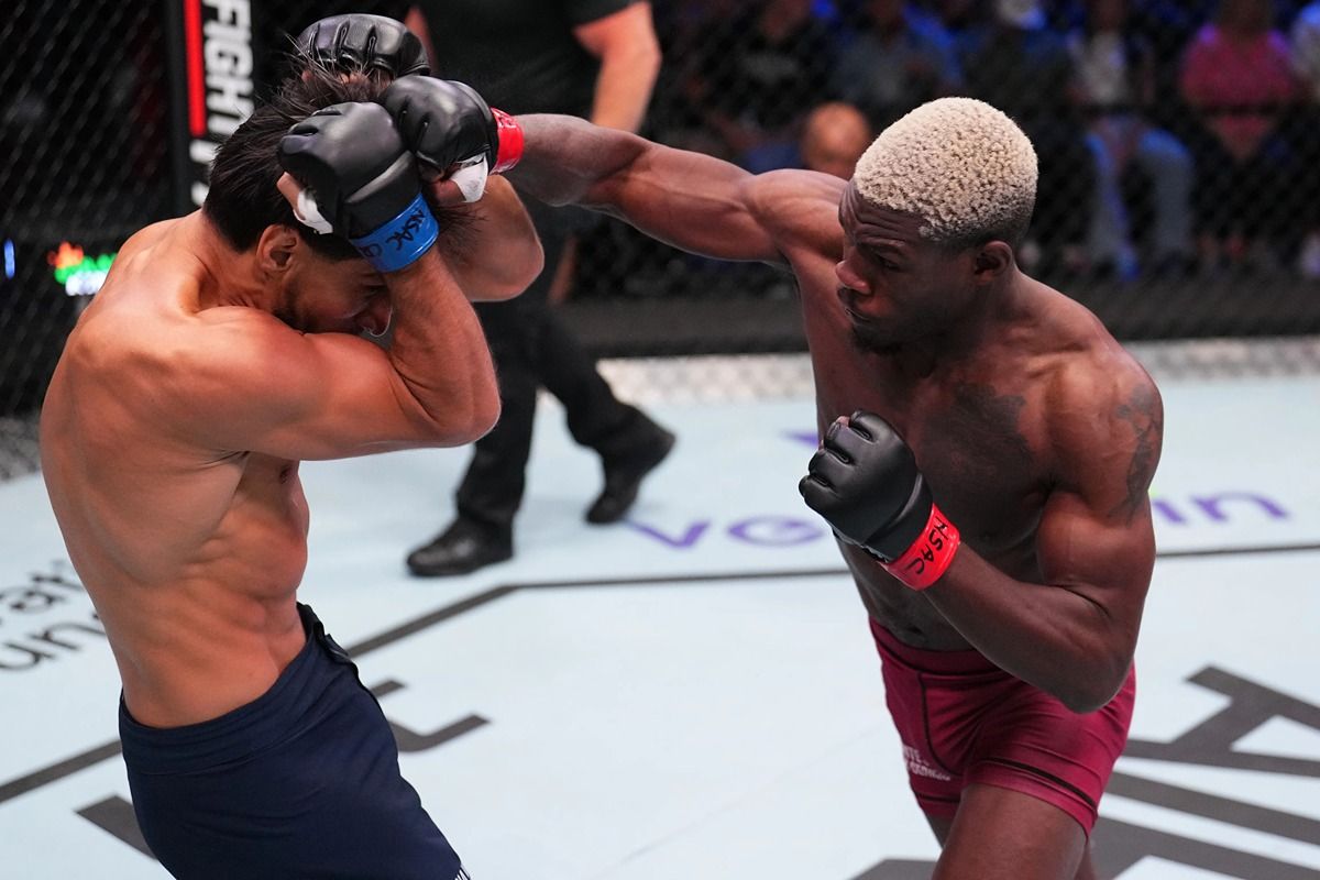 Bolaji Oki fires a right hand at Dylan Salvador. Credit: MMA Junkie.