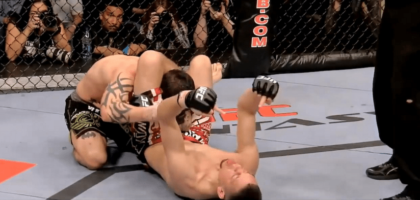 Nate Diaz secures Kurt Pellegrino in a triangle choke then puts up his middle fingers. Credits to: Zuffa LLC