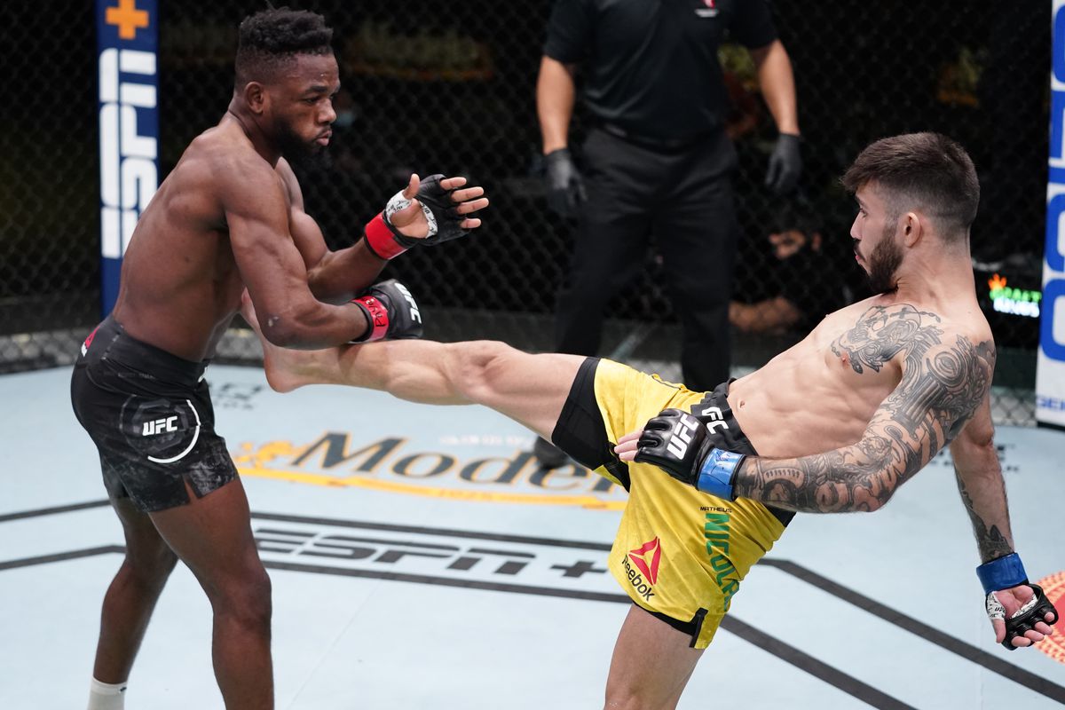 Matheus Nicolau fires a front kick at Manel Kape. Credit: MMA Fighting.
