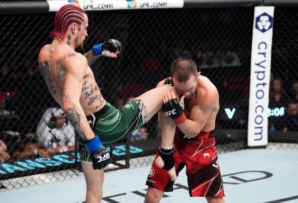 Sean O'Malley landing a big knee on Petr Yan. Credits to: Chris Unger-Getty Images.