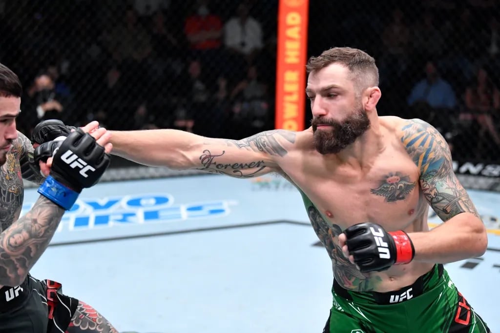 Michael Chiesa jabbing Sean Brady in their co-main event bout. Credits to: Chris Unger - Zuffa LLC.