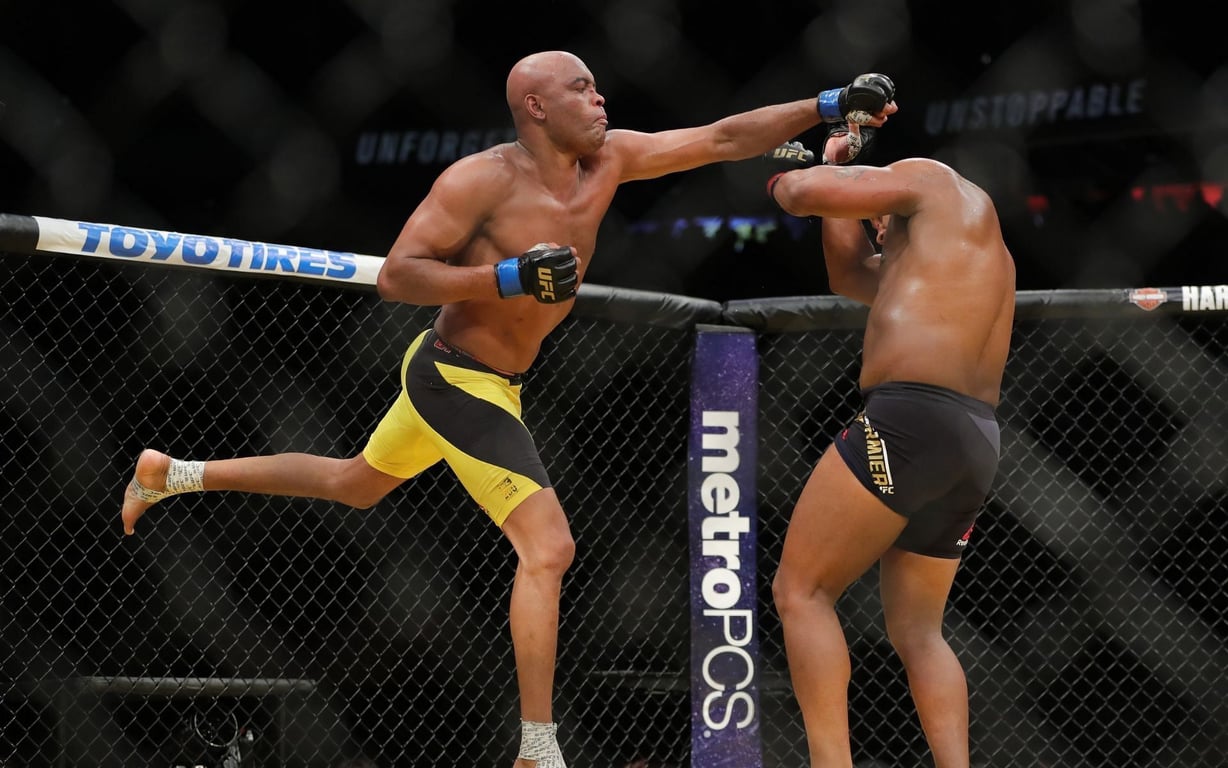 Anderson Silva throwing a superman punch at Daniel Cormier. Credits to: Zuffa LLC.