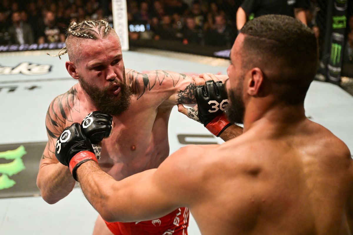 Nicolas Dalby closes the distance against Gabriel Bonfim. Credit: MMA Fighting.