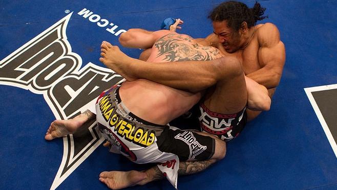 Benson Henderson catches Cowboy Cerrone in a guillotine choke. Credit: Zuffa LLC.