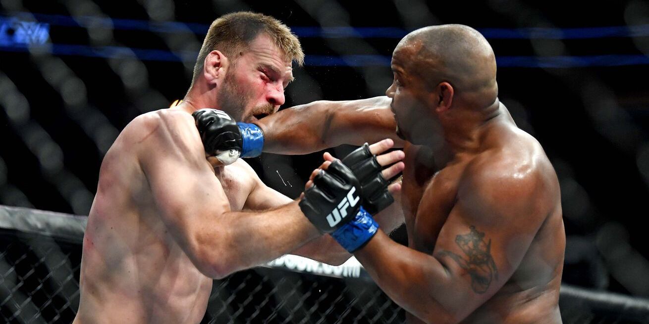 Daniel Cormier catching Stipe Miocic. Credits to: Stephen R. Sylvanie - USA TODAY Sports.