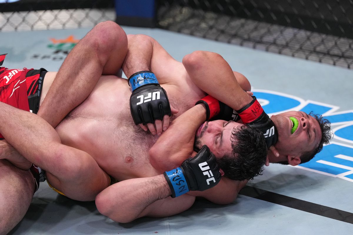 Caio Borralho applies a rear naked choke to Gadzhi Omargadzhiev. Credit: MMA Fighting.