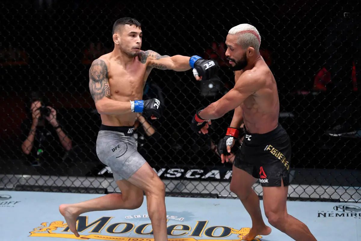 Alex Perez throws a left hand at Deiveson Figueiredo. Credit: Zuffa LLC.