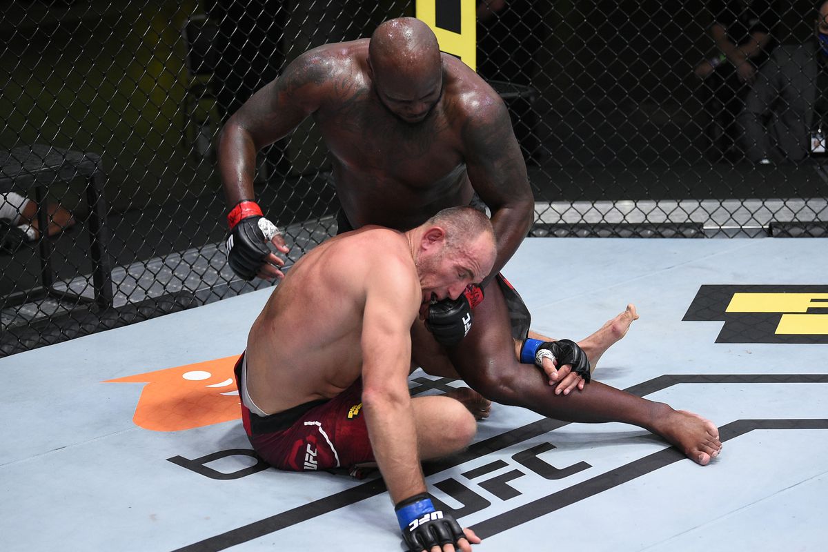 Derrick Lewis looks to land ground and pound on Aleksei Oleinik. Credit: MMA Fighting.