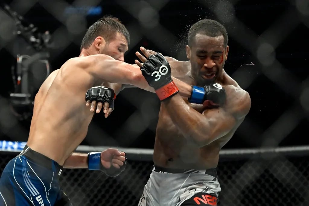 Shavkhat Rakhmonov cracking Geoff Neal. Credits to: AP Photo - David Becker.