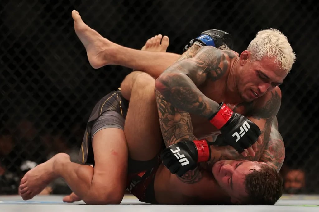 Charles Oliveira fighting Dustin Poirier at UFC 269 inside the T-Mobile Arena. Credits to: Stephen R. Sylvanie - USA Today Sports.