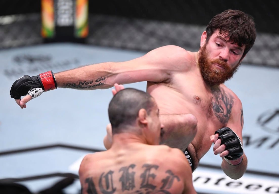 Jim Miller headkicking Vinc Pichel. Credits to: Zuffa LLC