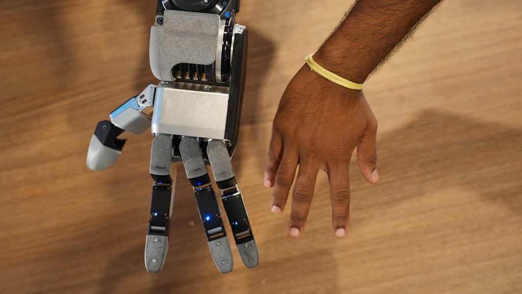 Side-by-side comparison of the new Atlas robot hand and a human hand