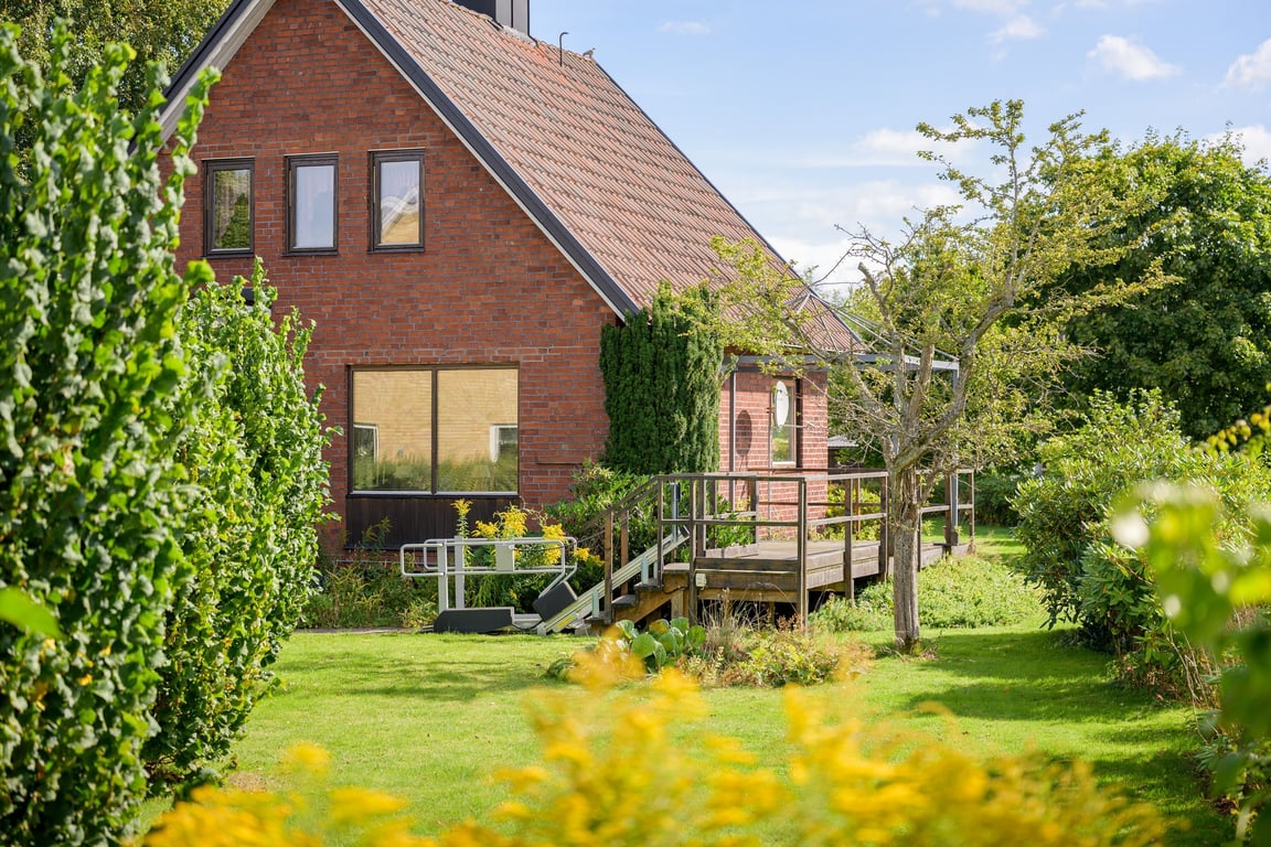 Uteplats intill huset med trädgården nära till hands.
