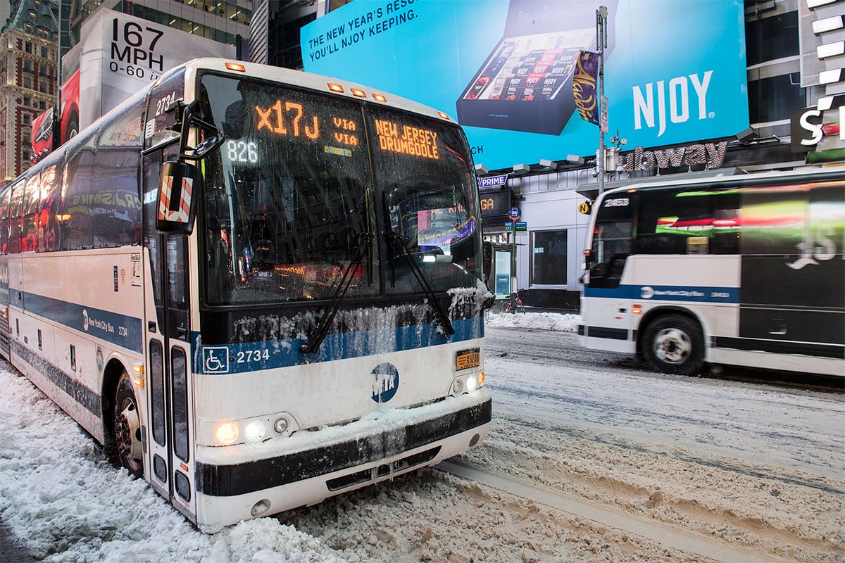 Bus driving in snow.