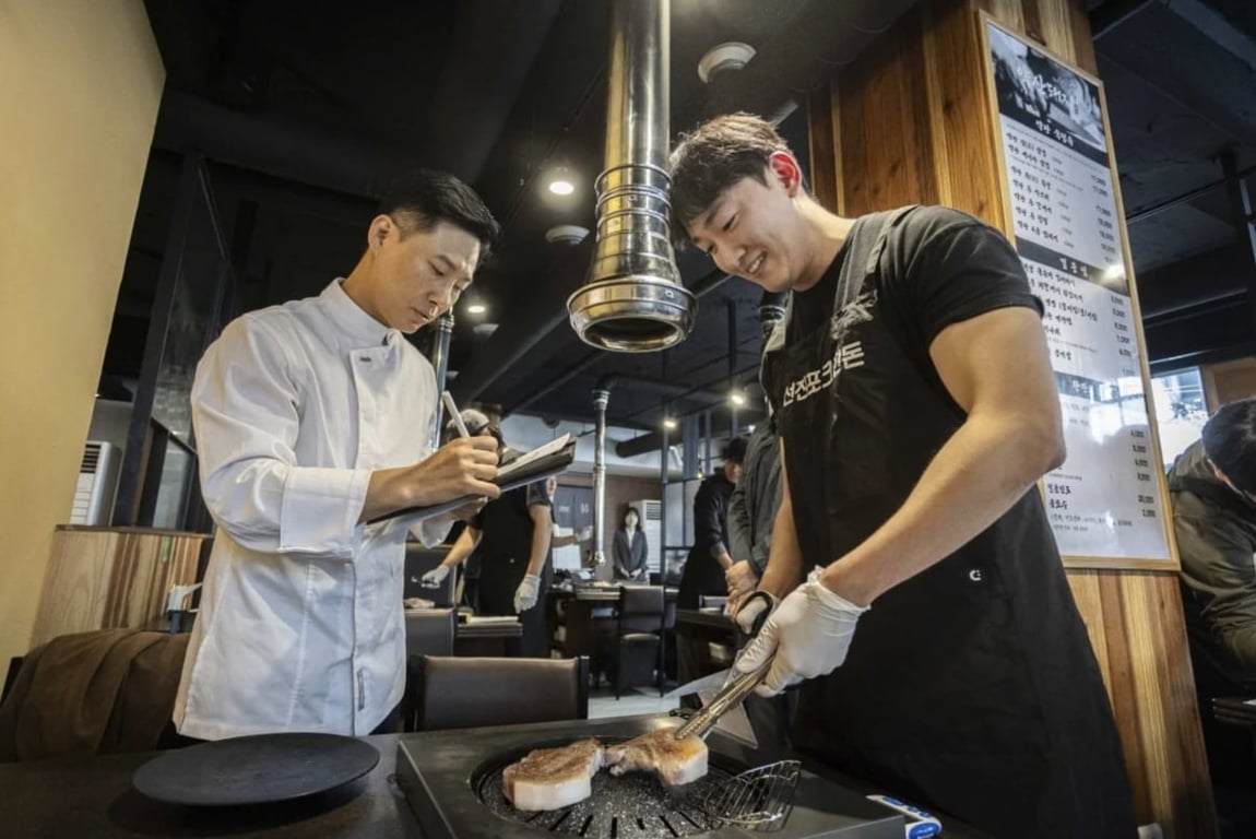 Cha Ho-myeong, head of the Food Solutions Team at Sunjin's Advanced Technology Research Institute, evaluates candidates during the Grilling Meister certification exam. Photo courtesy of Sunjin.