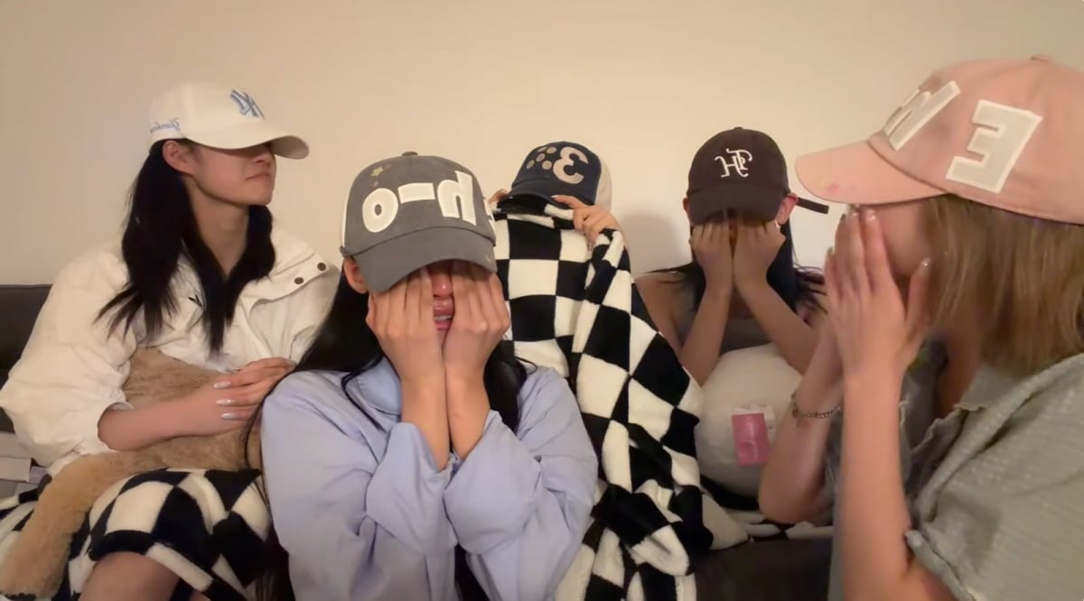 RESCENE members tear up during a livestream after learning "LOVE ATTACK" had reached No. 1 on Melon's Top 100. / @RESCENE_official on YouTube