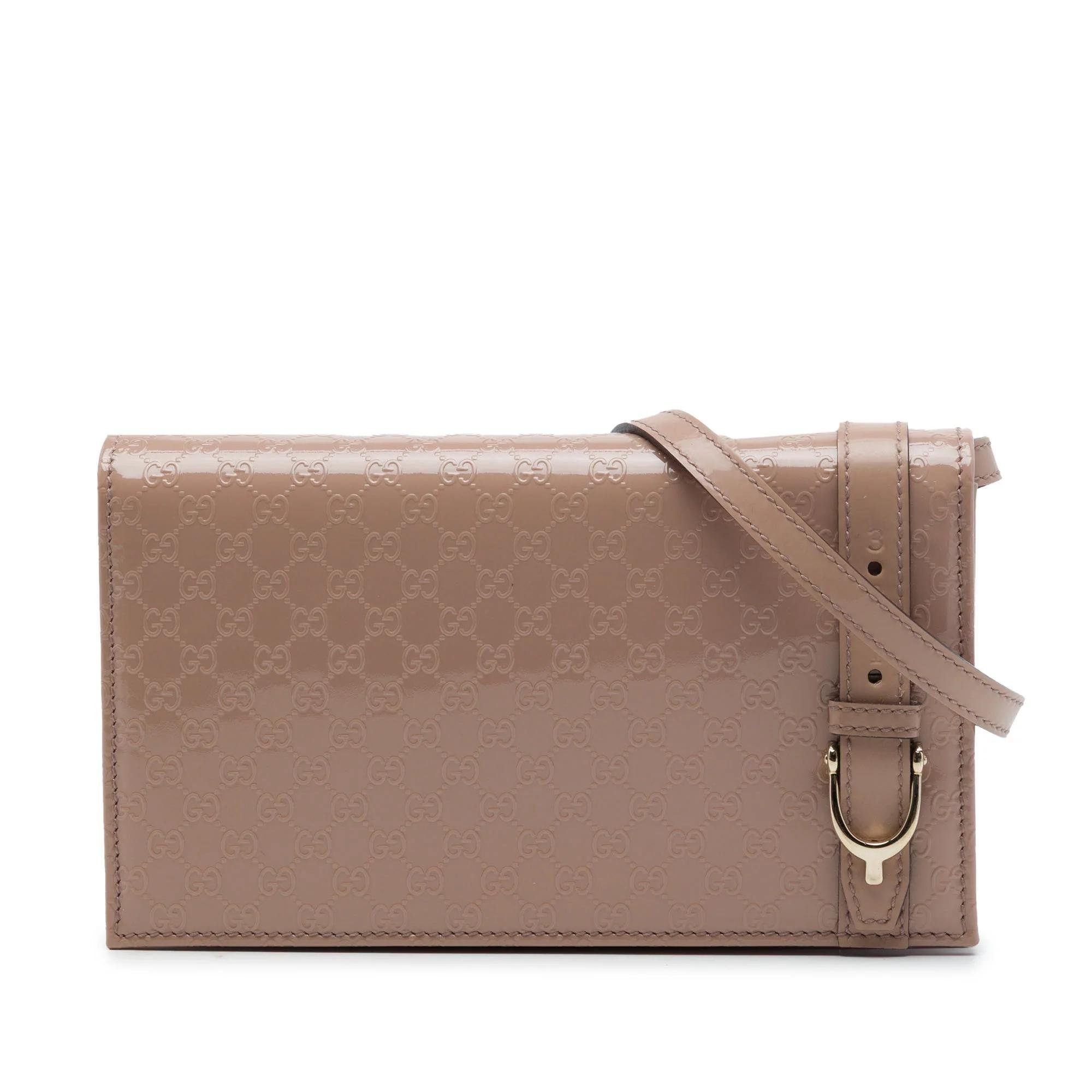 Stirrup patent leather handbag