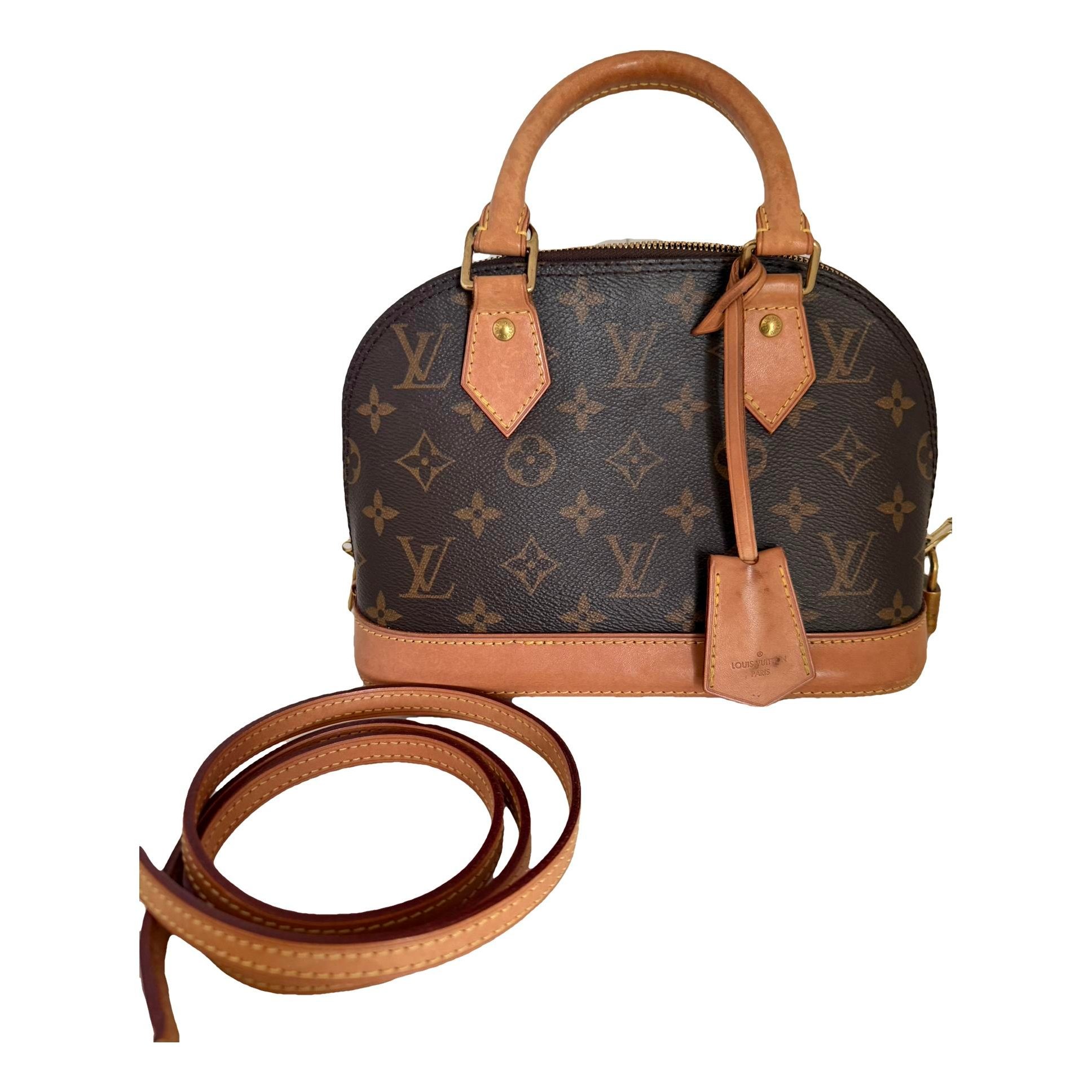 Louis Vuitton Alma BB cloth handbag