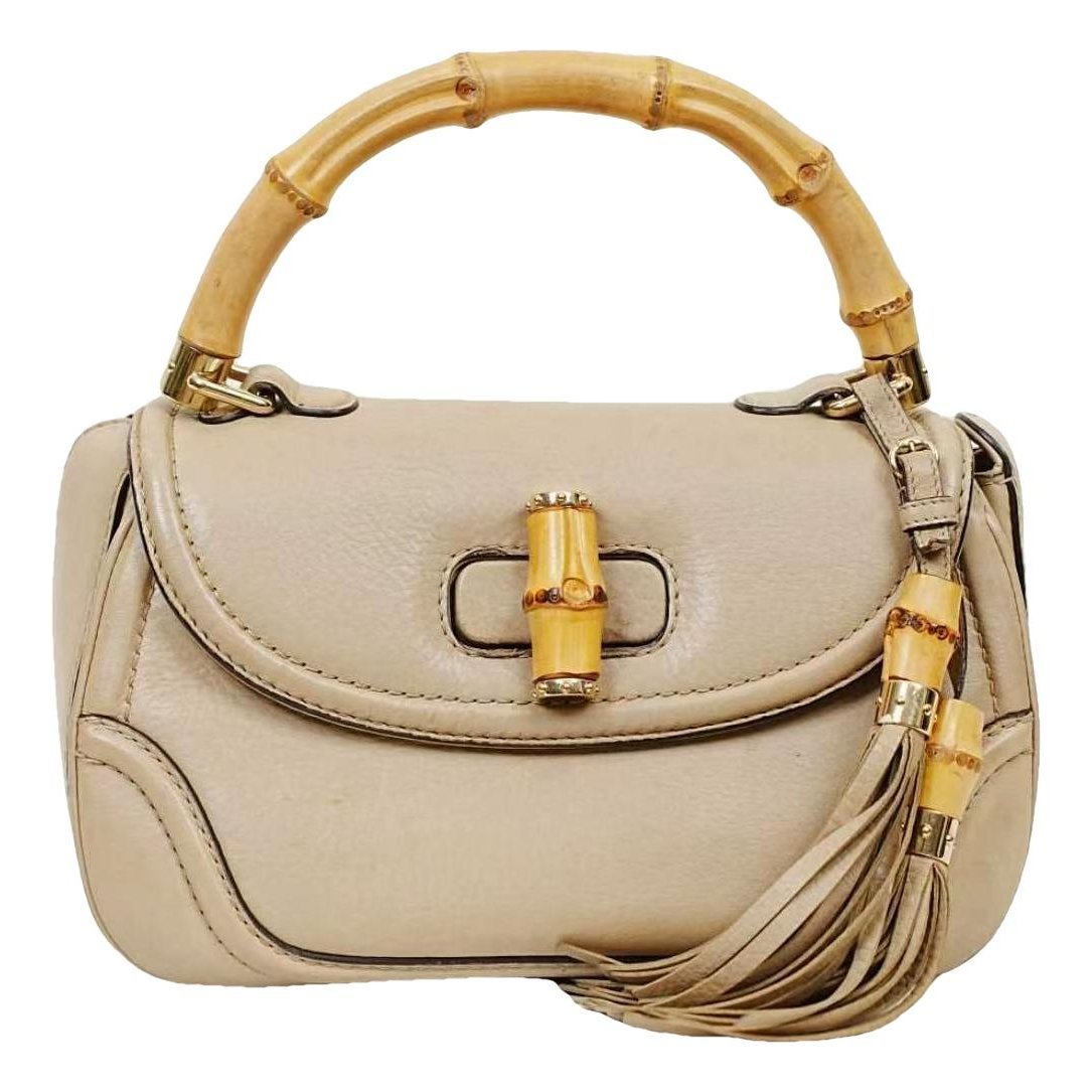 Convertible Pompon Bamboo Top Handle leather handbag