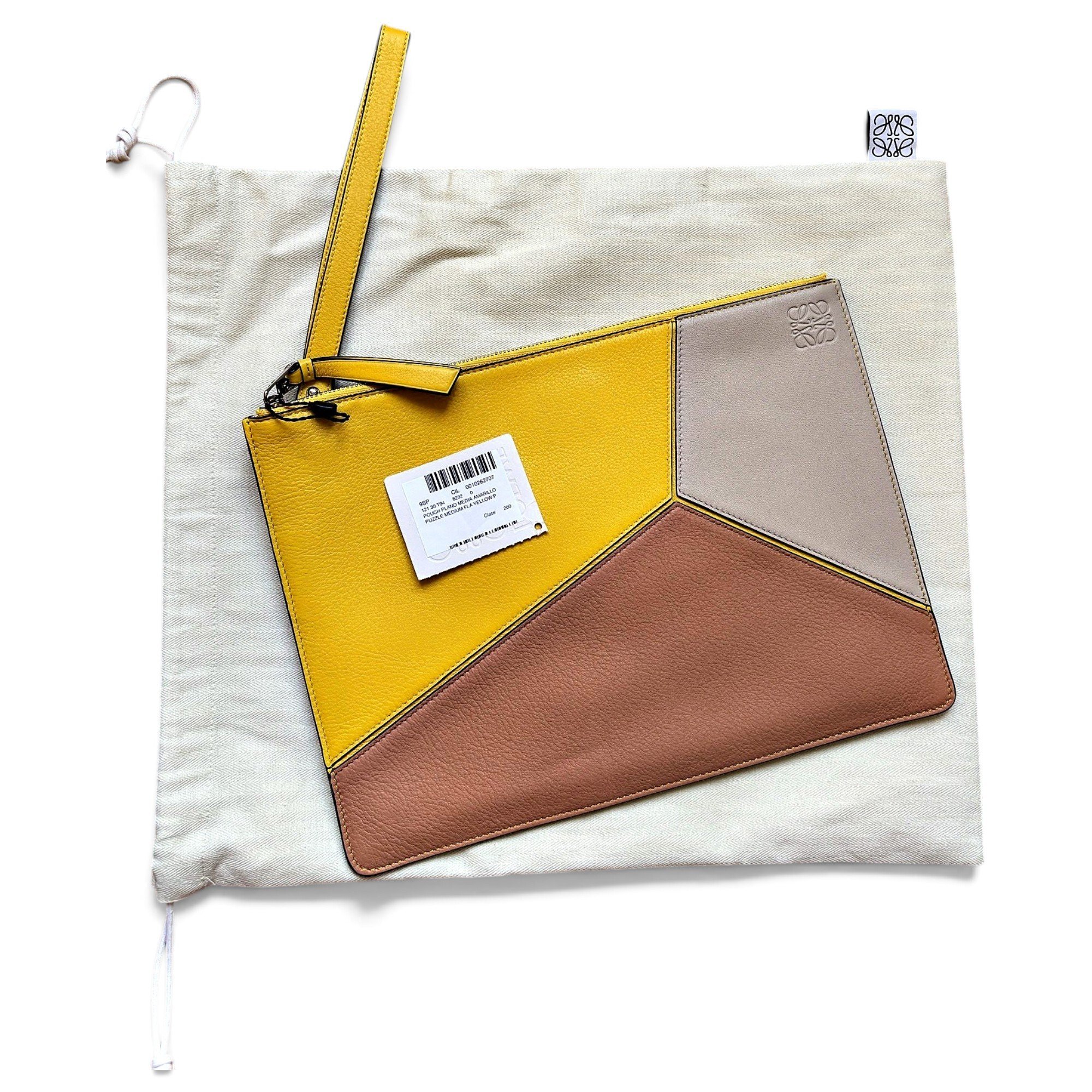 Puzzle leather clutch bag