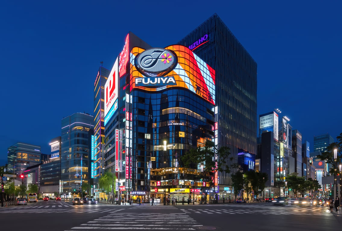 Ginza street corner at blue hour with neon signs and the Fujiya building