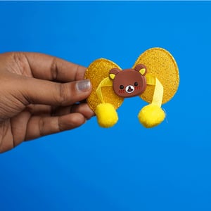 Shiny Stone Finish Bow Shape Pompom Hair Clip - Yellow