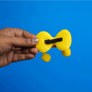 Shiny Stone Finish Bow Shape Pompom Hair Clip - Yellow