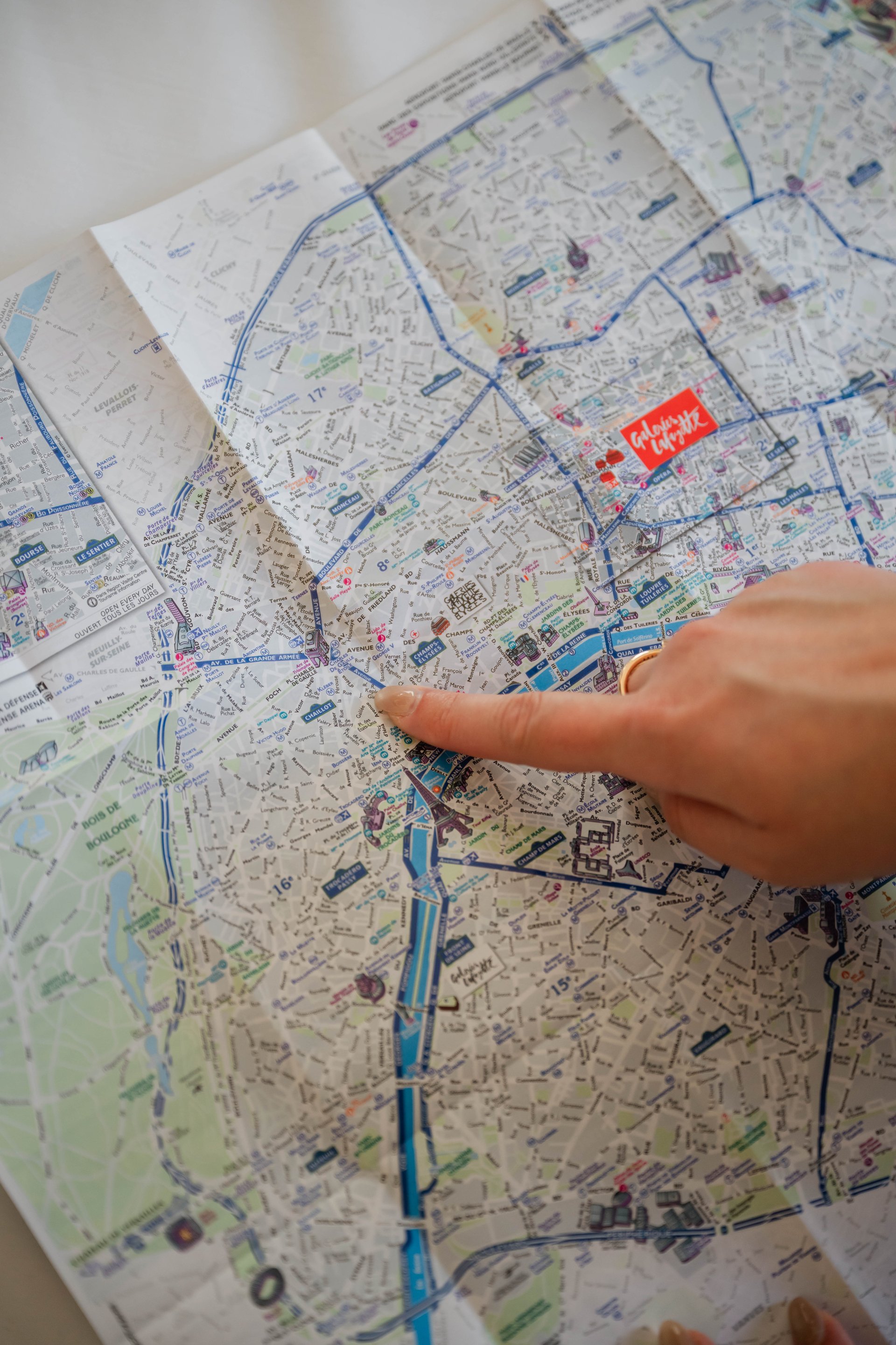 Main pointing to a detailed city map with marked attractions and tourist routes.