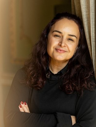 Smiling portrait of a team member, arms crossed