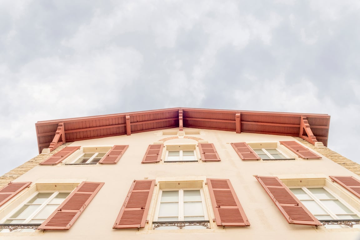 Saint-Julien, Biarritz: façade with red shutters seen from below