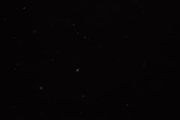 Dust particles swirling in darkness 4K