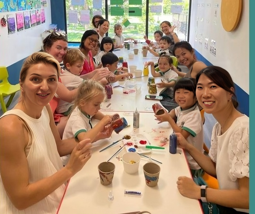 Mothers and children enjoying a creative art activity together.