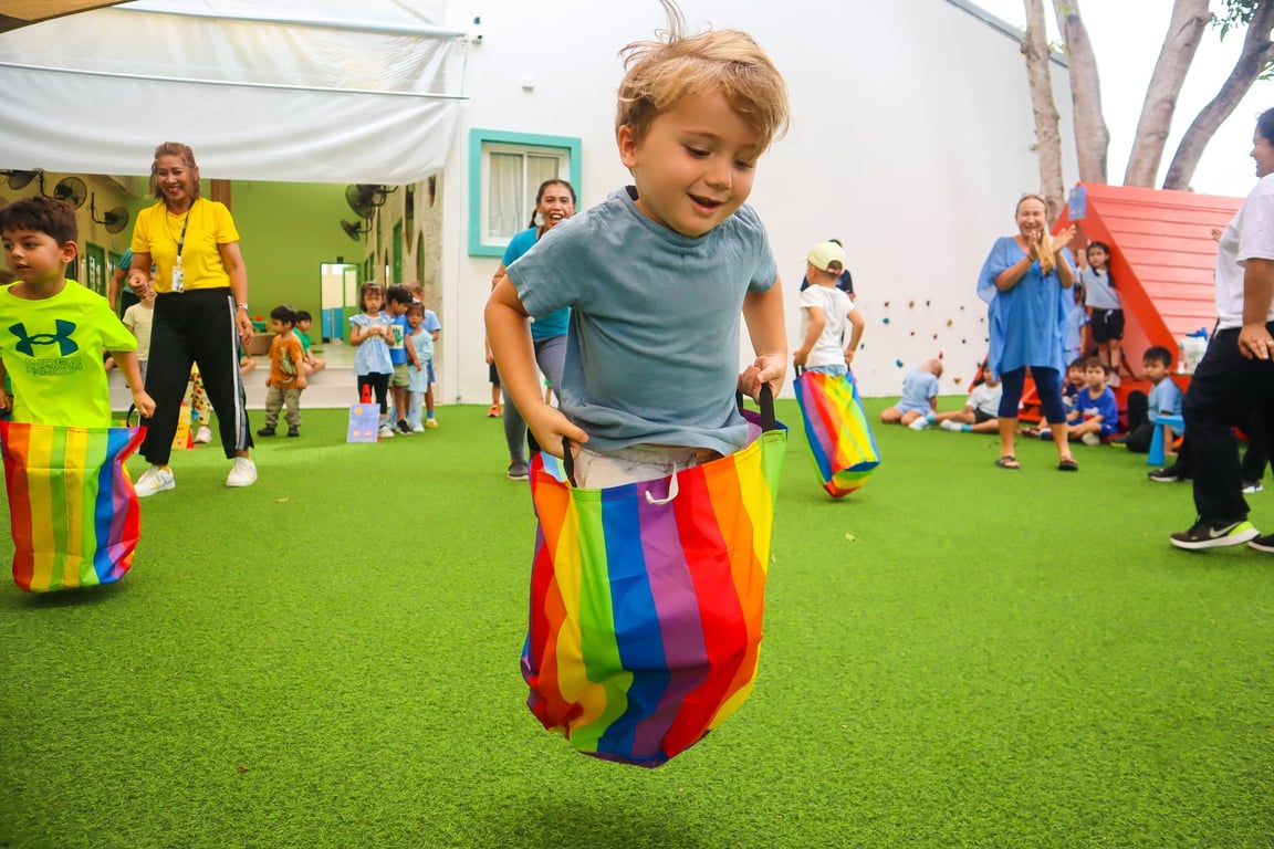 Foundation and Nursery students compete in fun races, including a sack race during sports day.