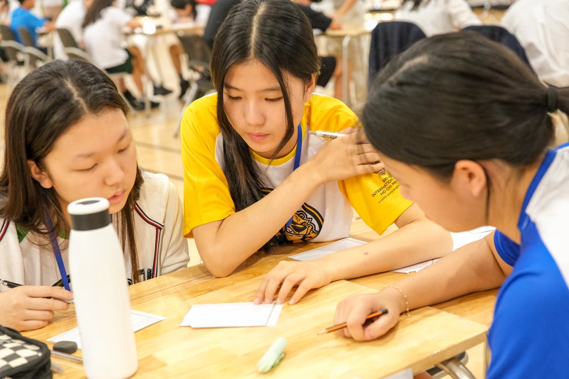 Students collaborating on a task during a math competition.