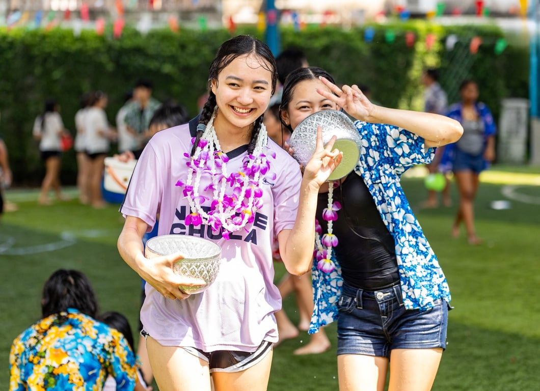 Students honoring Thai New Year with water, tradition, and unity at a Songkran Celebration.