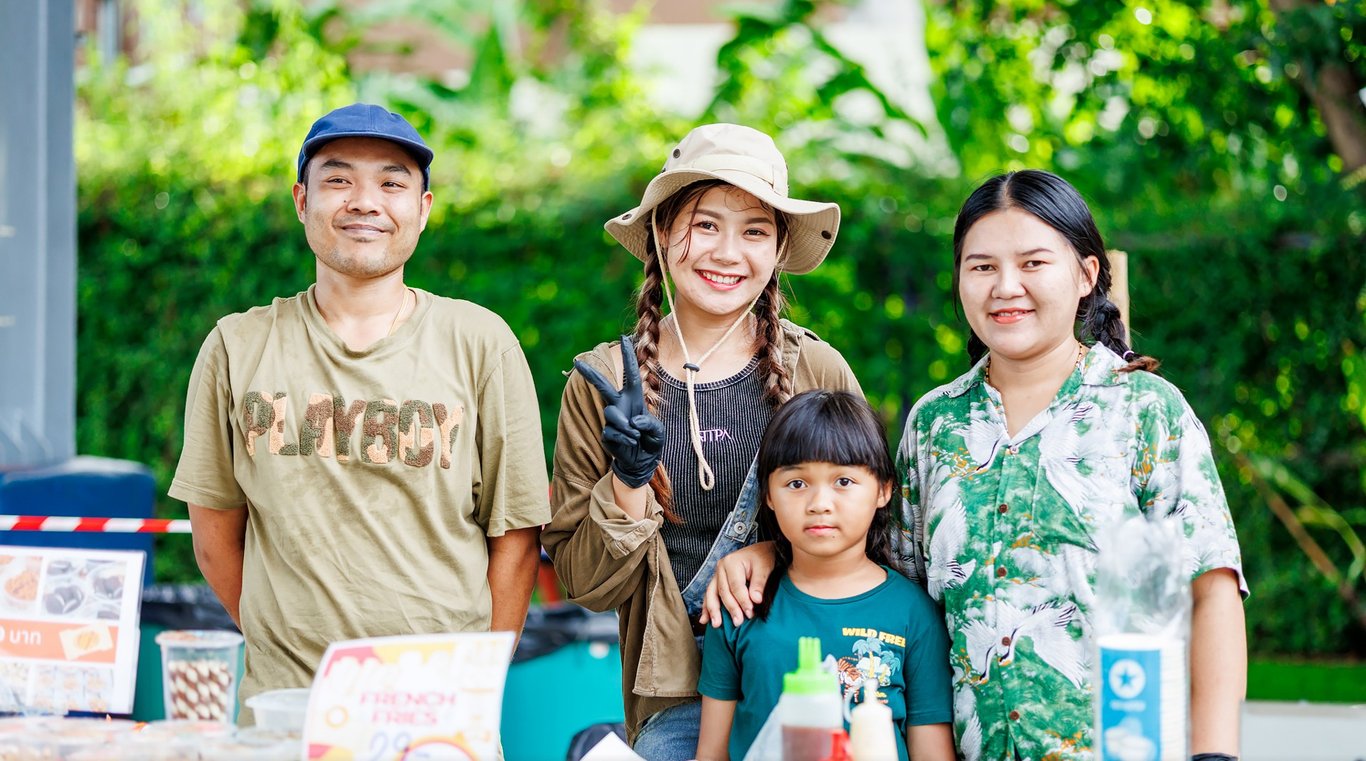 A family posing at the REPS community market.