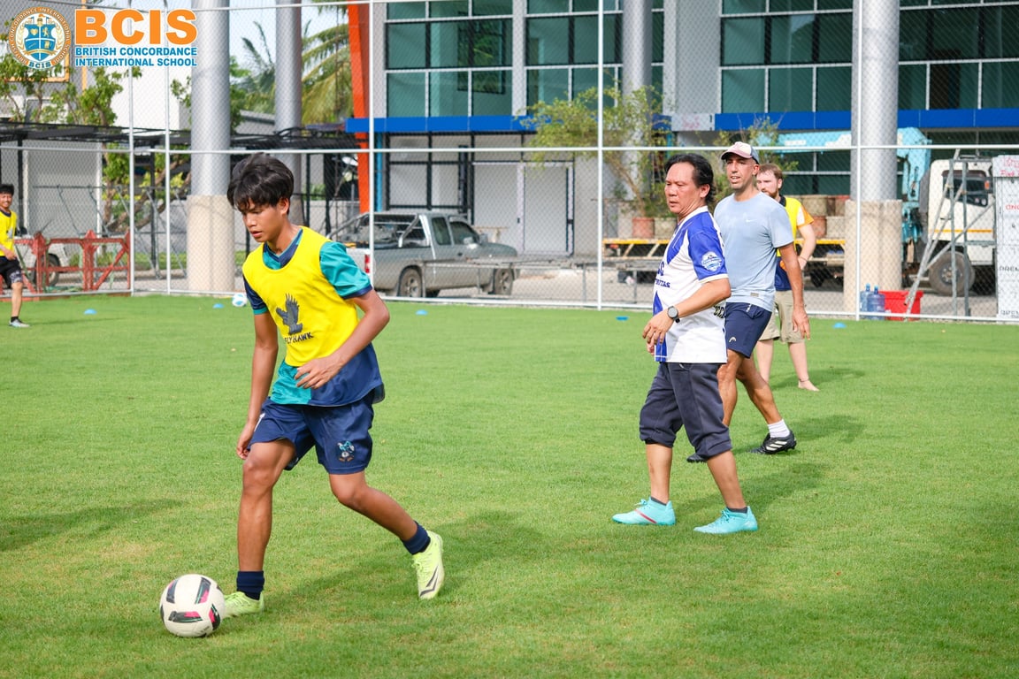 Teachers and parents facing off in a friendly football match at BCIS.