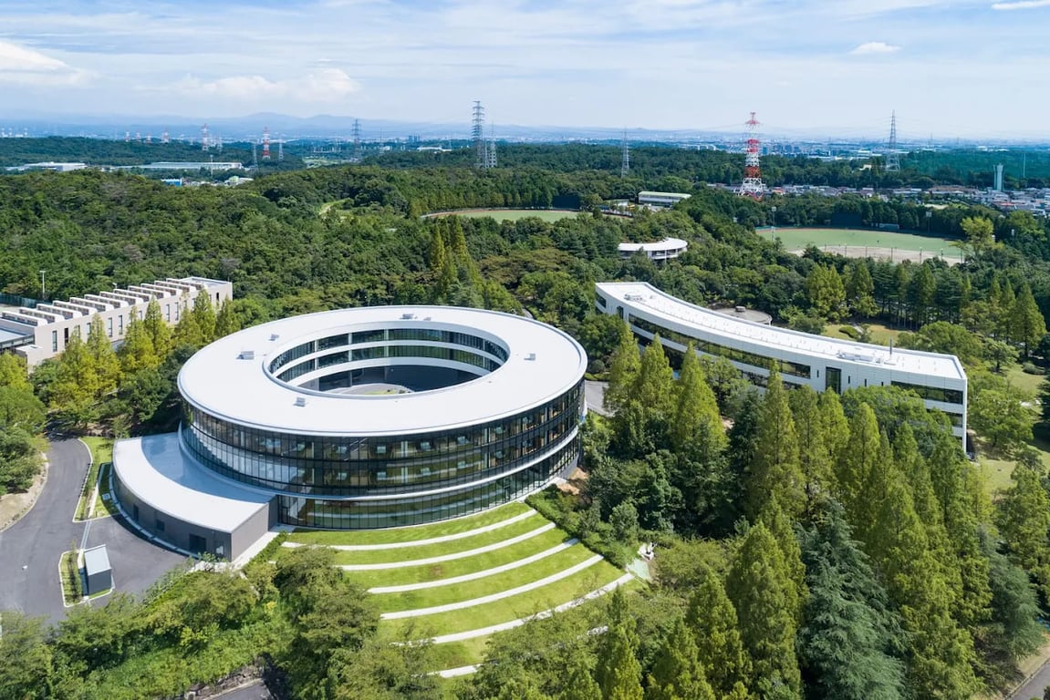An aerial view of the iconic circular campus building at NUCB International College.