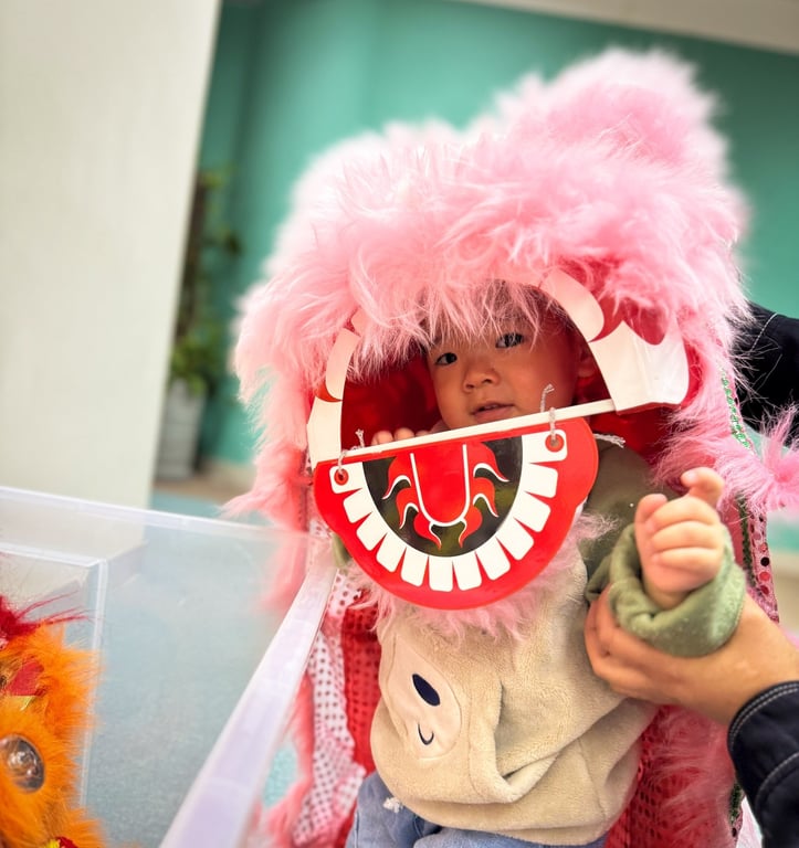 Young student trying on a traditional Chinese lion head at school.