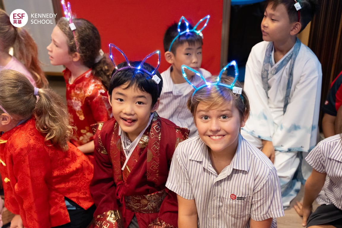 Students celebrating the Mid-Autumn Festival in colourful traditional attire.