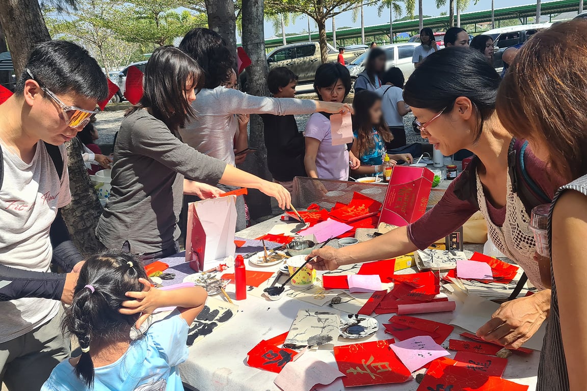 Families exploring Chinese culture through food and art activities.