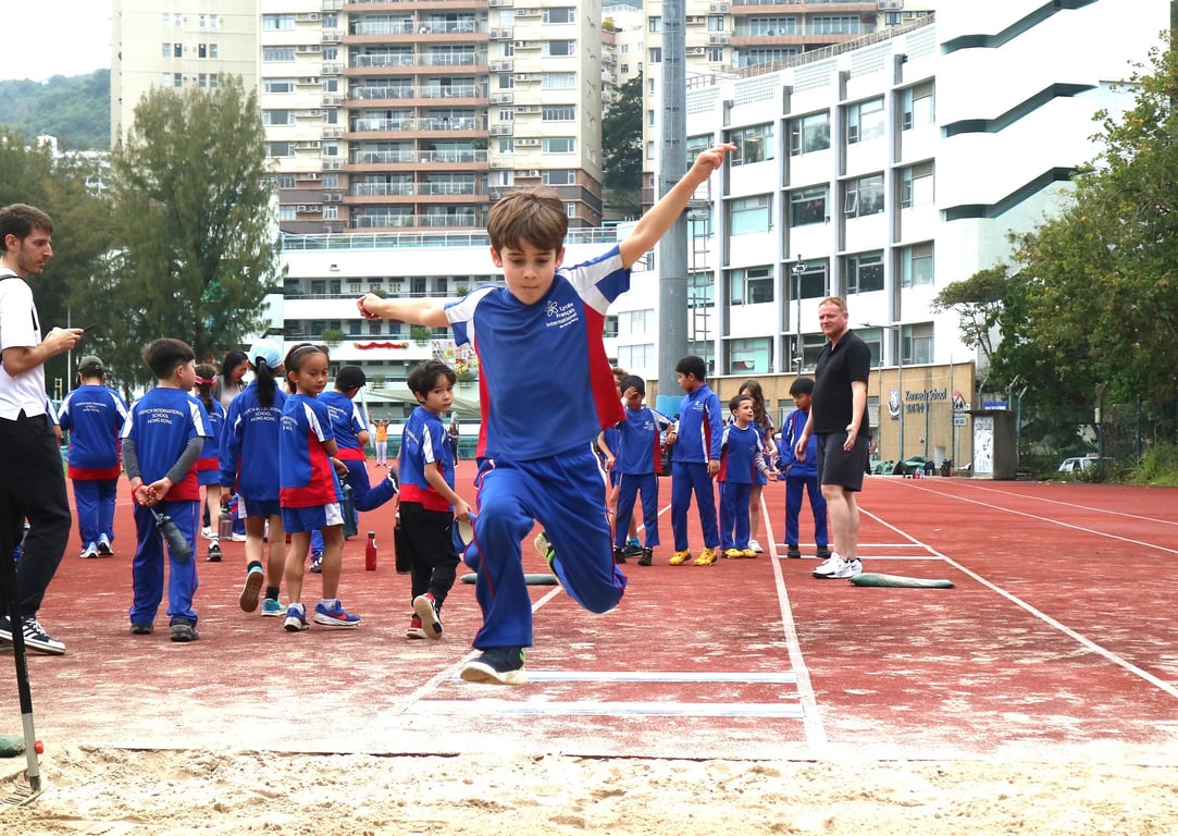 CE1/Y3 and CE2/Y4 students competing in long jump during Sports Day.