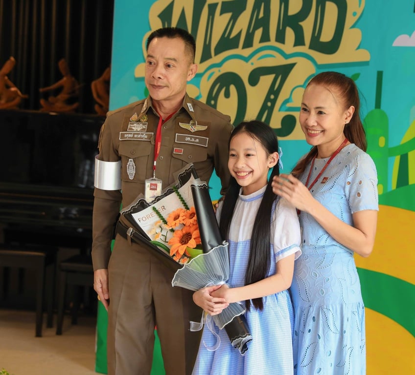 Student with her proud family during a school performance.