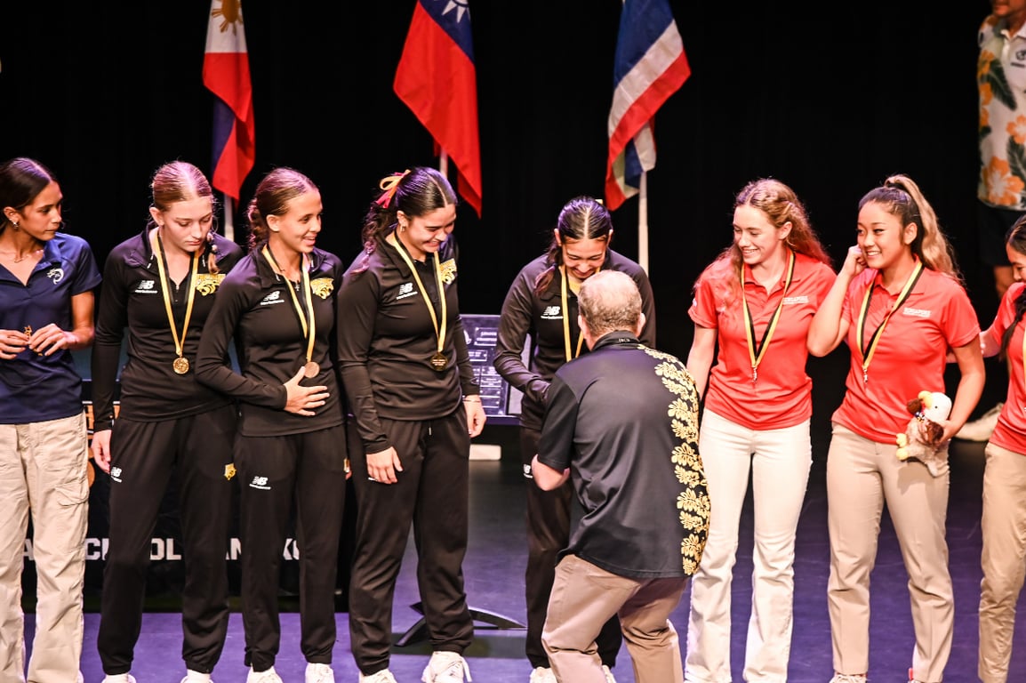 High school students receiving medals at a sports event.